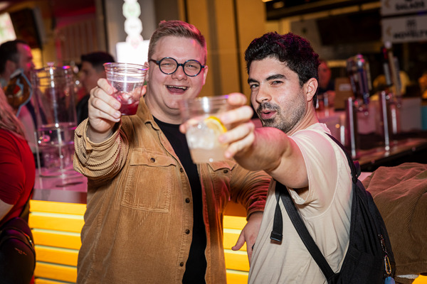Two people cheers at High Street Place Food Hall